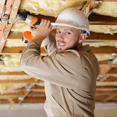 a chambers timber employee installing insulation material